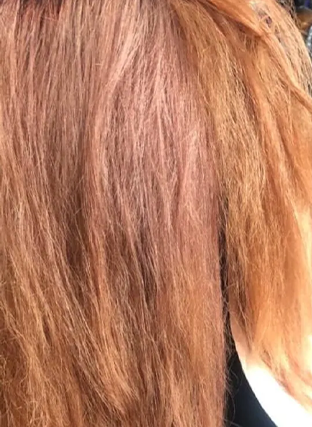 Close-up of straight brown and blonde hair strands in soft light