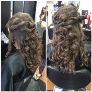 Two views of a braided half-up curly hairstyle with loose ringlets in a salon chair